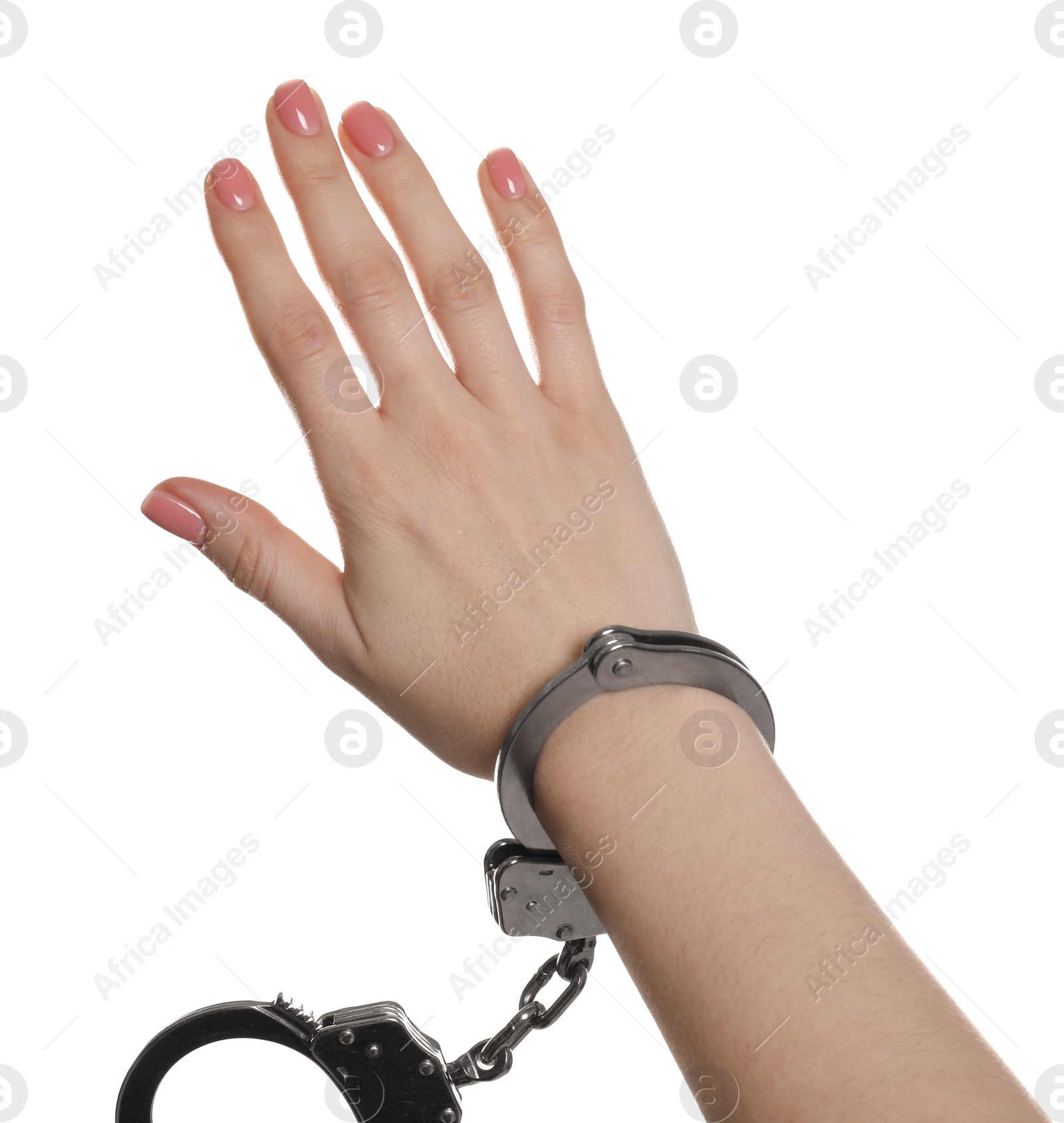 Photo of Freedom concept. Woman with handcuffs on her hand against white background, closeup