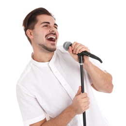 Young handsome man singing in microphone on white background