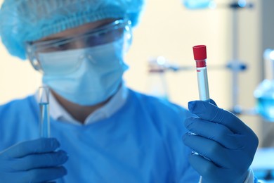 Photo of Scientist working with samples in laboratory, focus on hand. Medical research