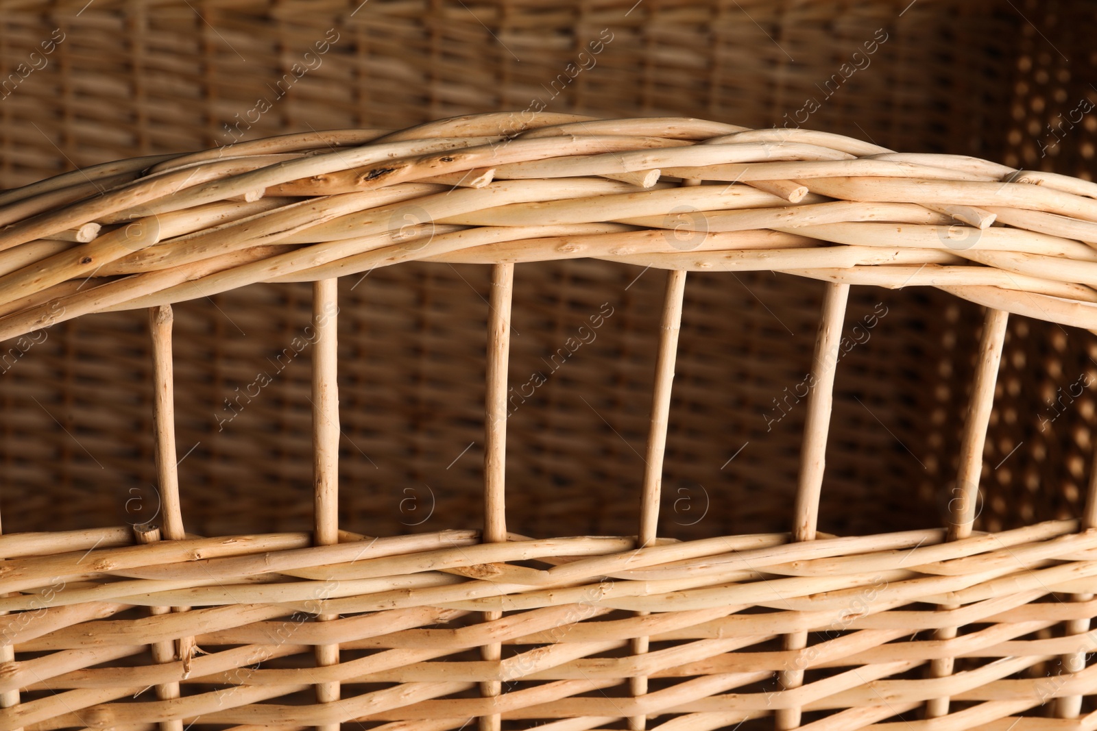 Photo of Handmade wicker basket made of natural material, closeup view