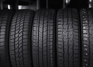 Photo of Black car tires in service store, closeup