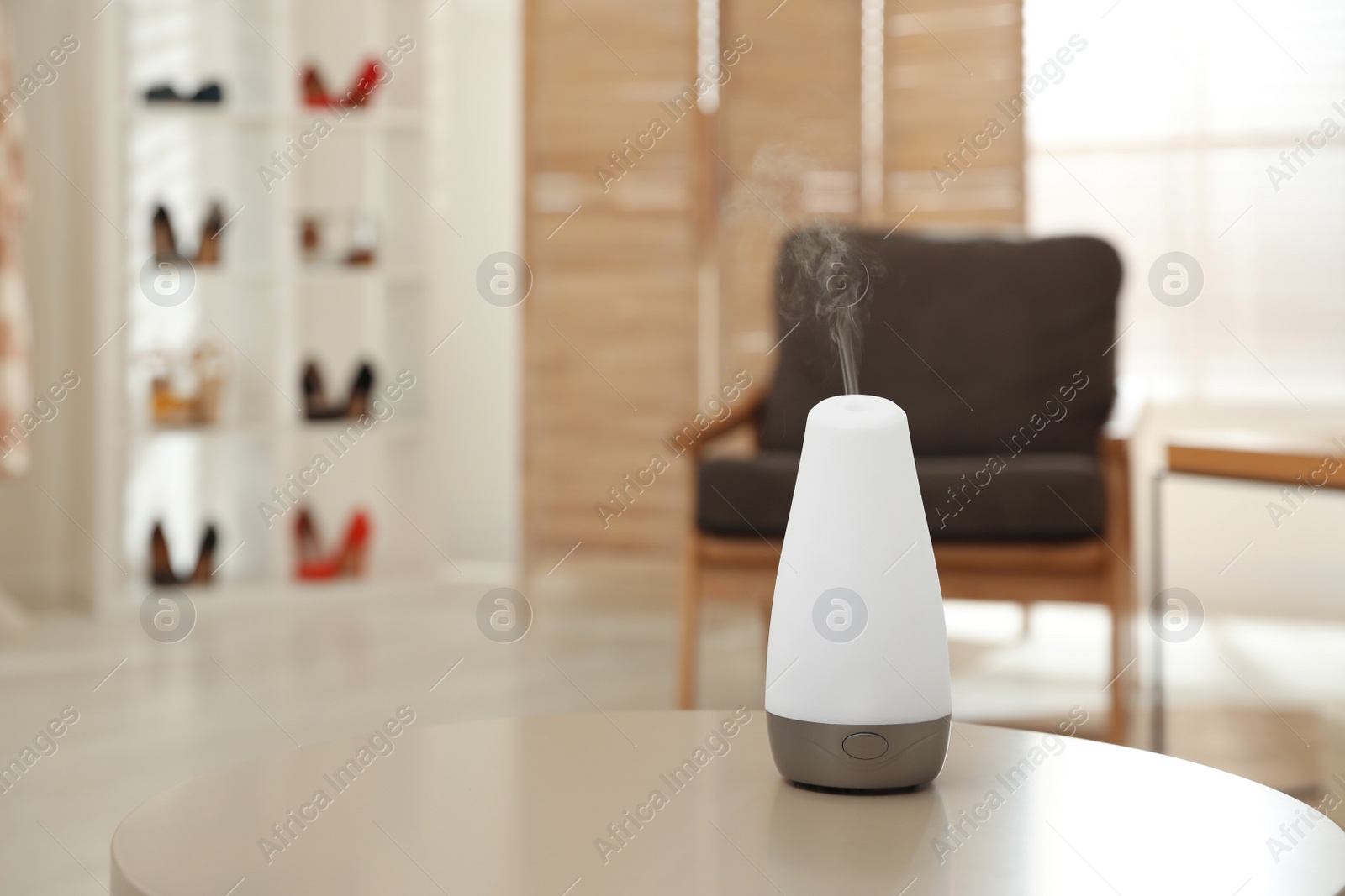 Photo of Aroma oil diffuser on table indoors, space for text. Air freshener