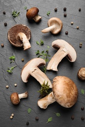 Photo of Flat lay composition with fresh wild mushrooms on black table
