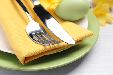 Photo of Festive Easter table setting with egg on white background, closeup