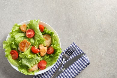 Photo of Delicious salad with chicken and cherry tomato served on light grey table, top view. Space for text