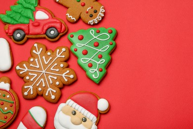 Different tasty Christmas cookies on red background, flat lay. Space for text