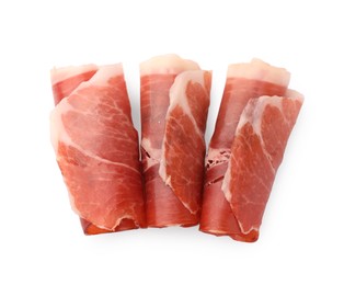 Photo of Rolled slices of delicious jamon isolated on white, top view