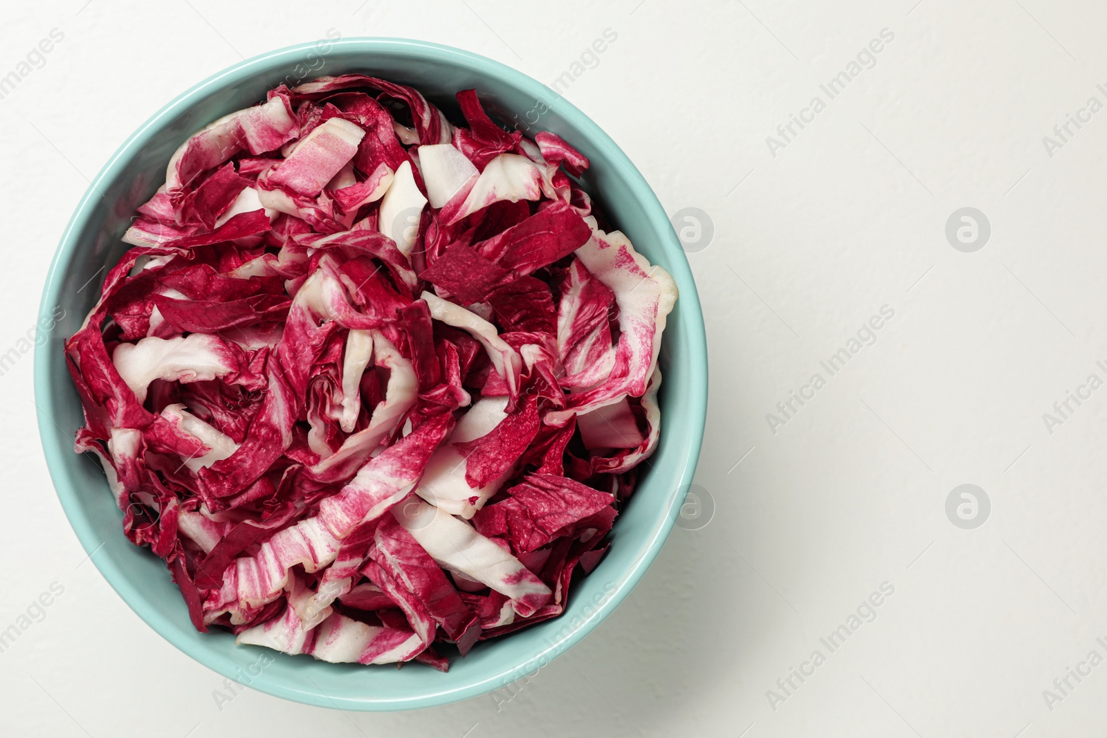 Photo of Cut radicchio on white background, top view