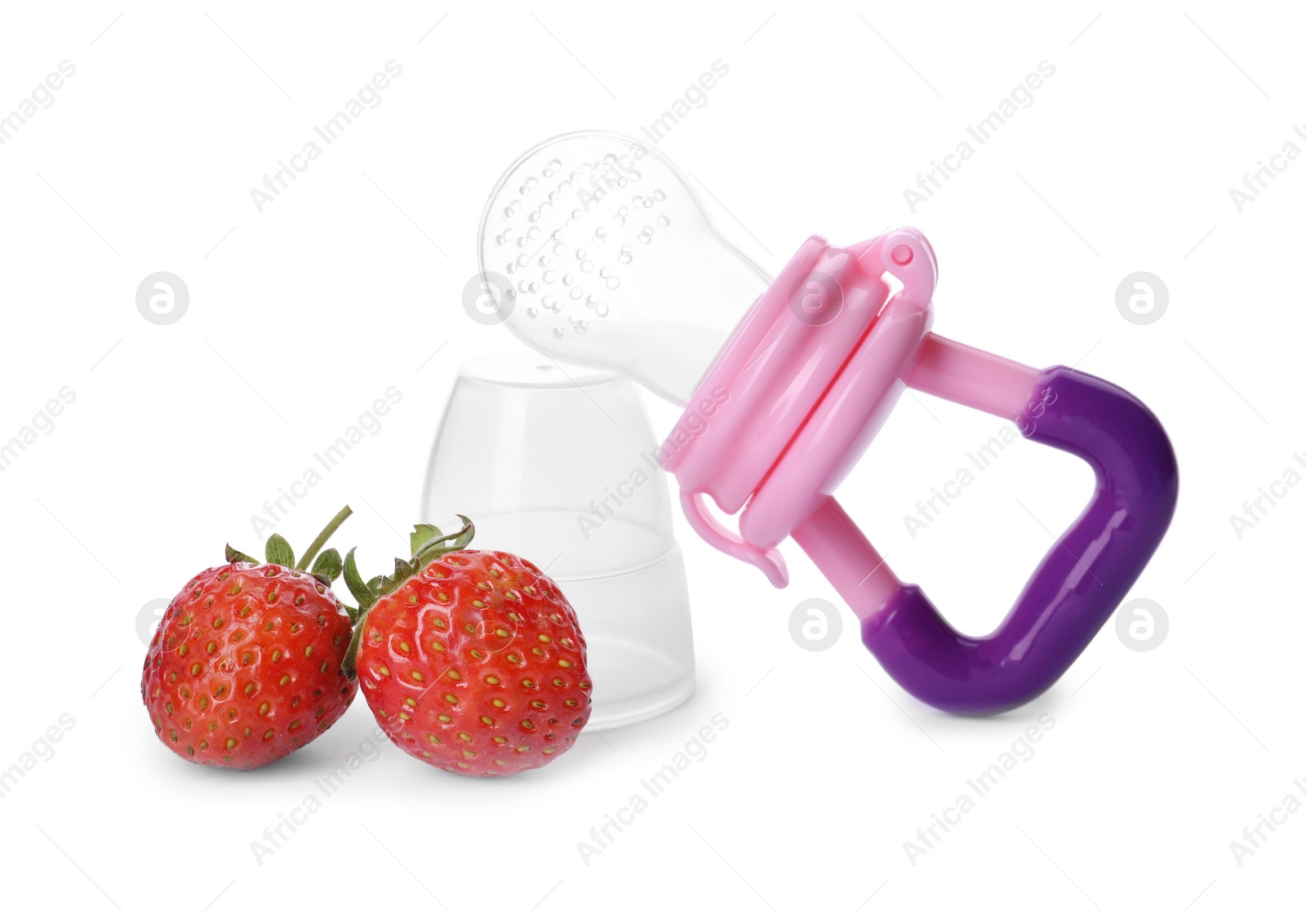 Photo of Empty nibbler and strawberries on white background. Baby feeder