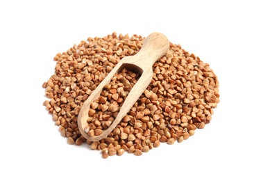 Scoop and pile of uncooked buckwheat on white background