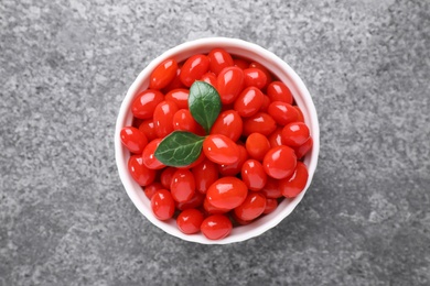 Bowl with fresh goji berries on grey background, top view