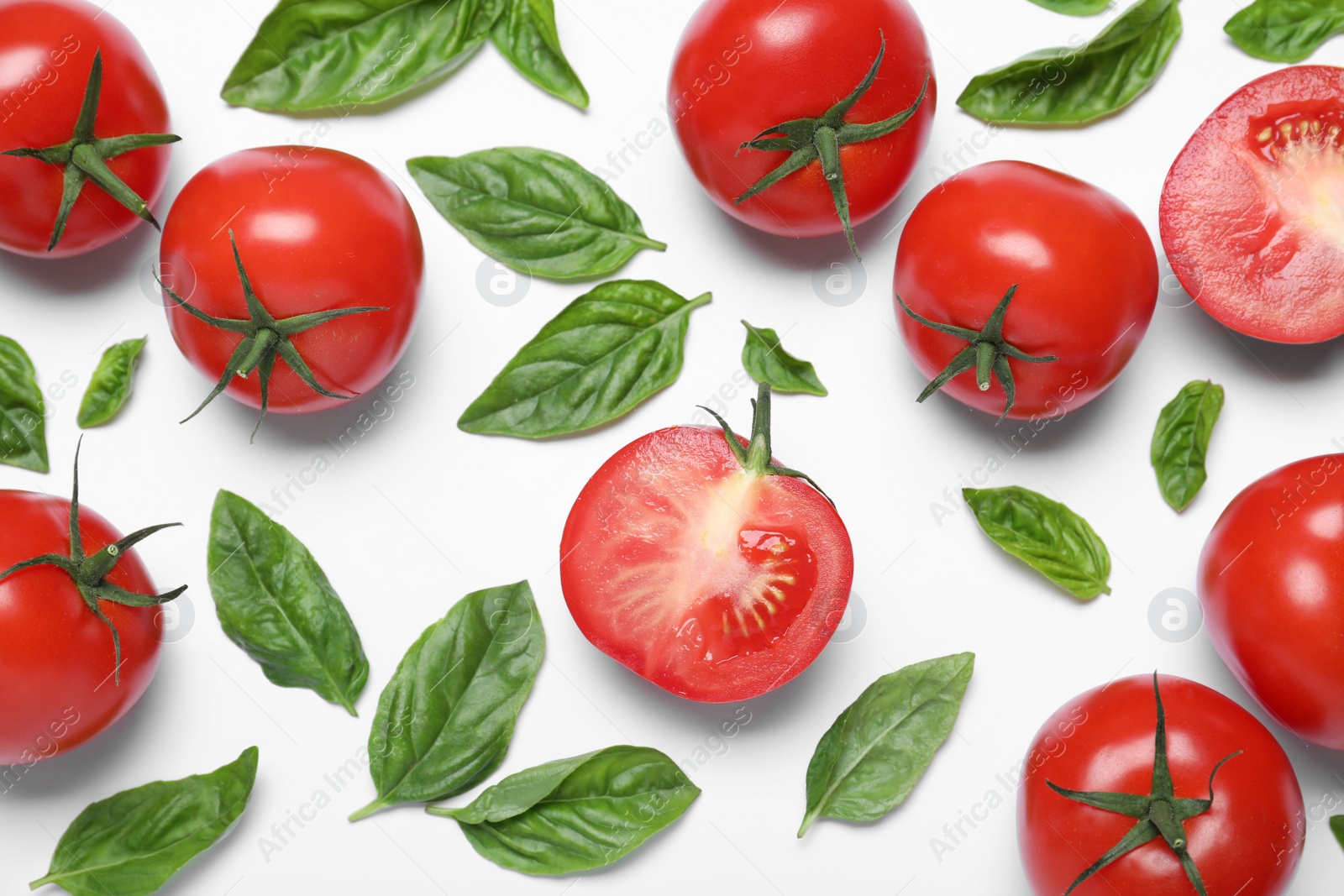 Photo of Fresh basil leaves and tomatoes on white background, flat lay