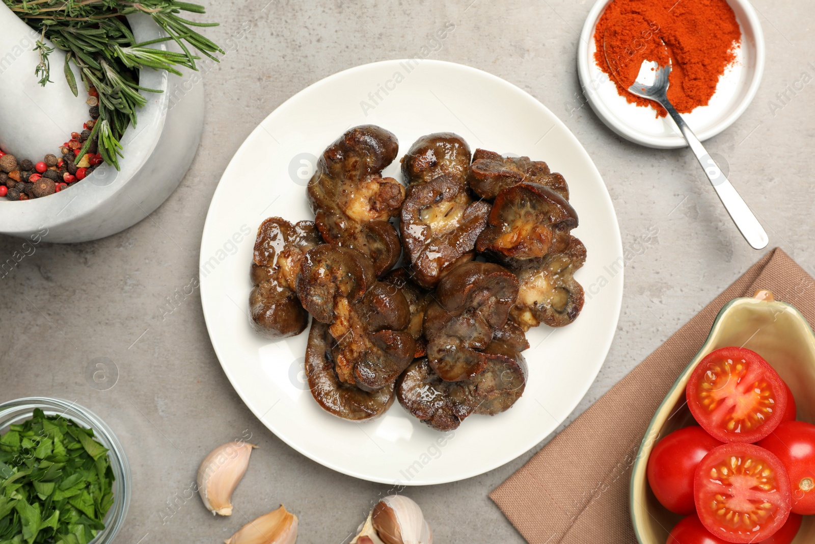 Photo of Delicious kidneys with thyme and ingredients on light table, flat lay