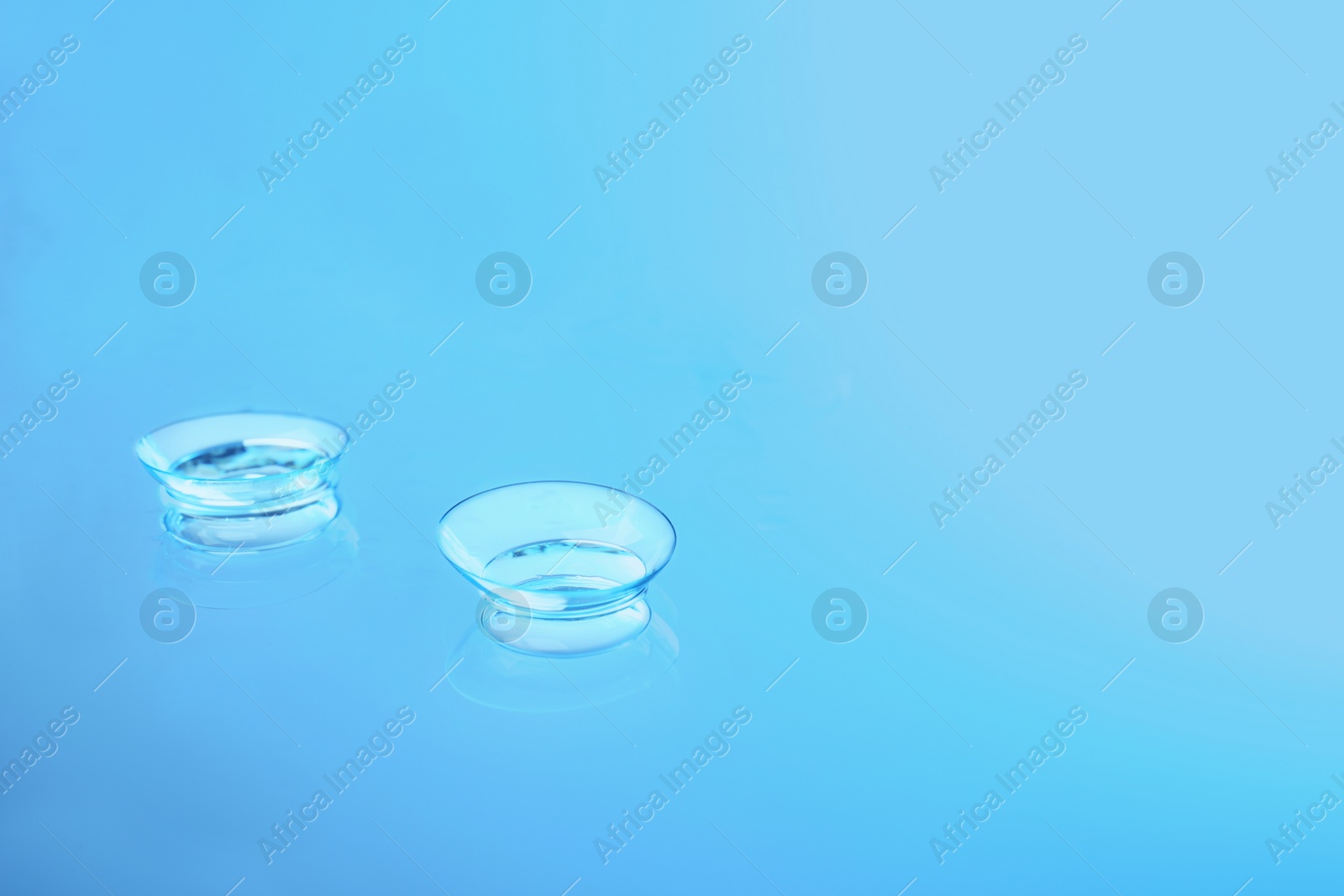 Photo of Contact lenses on glass background