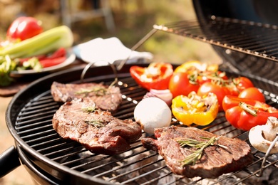 Modern grill with meat and vegetables outdoors, closeup