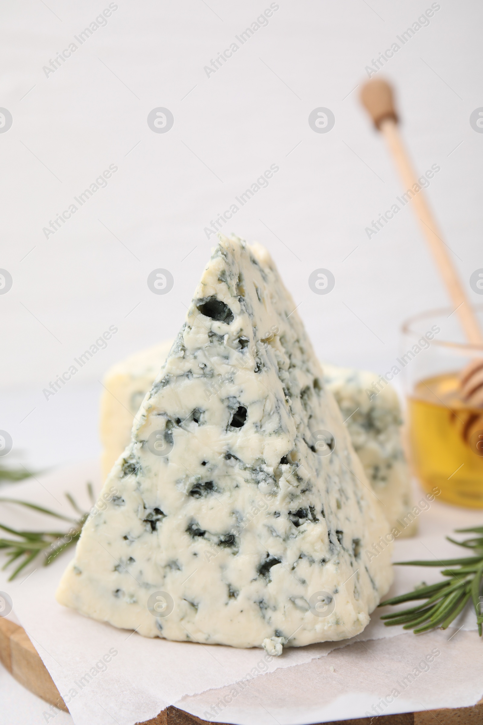 Photo of Tasty blue cheese with rosemary on white table