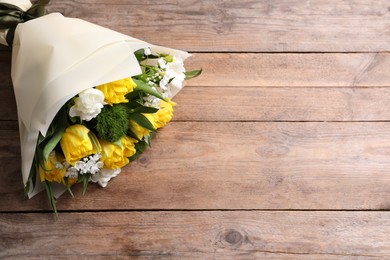 Photo of Beautiful bouquet with peony tulips on wooden table, top view. Space for text