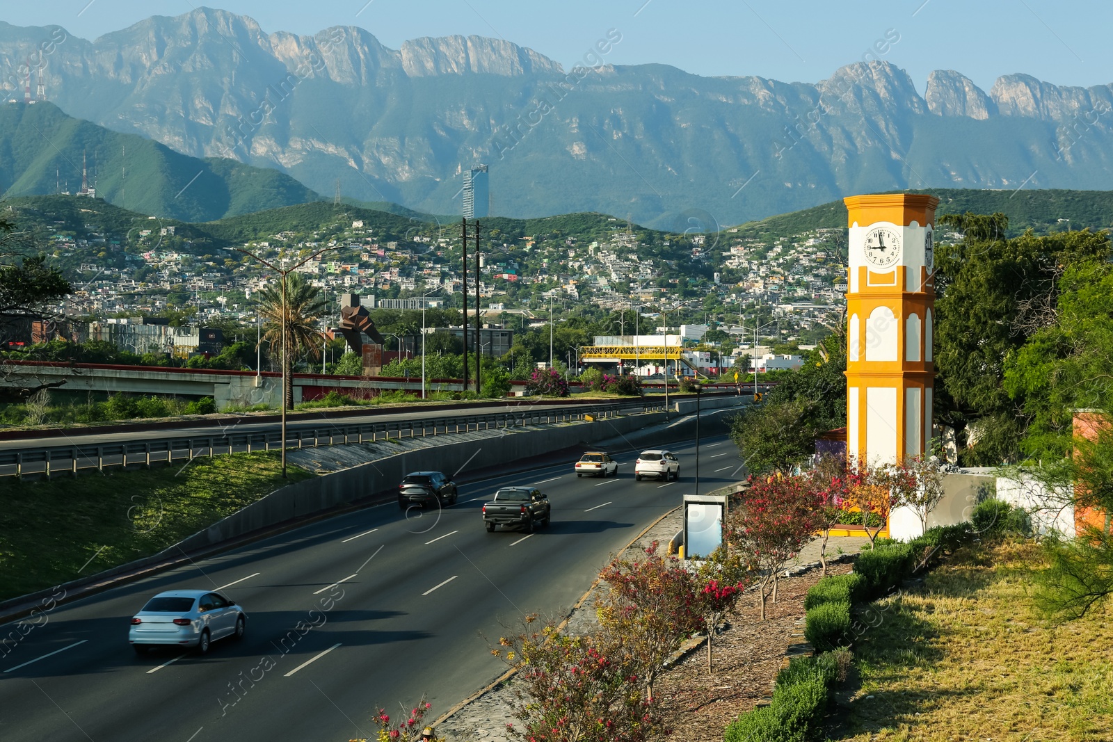 Photo of Picturesque view of city and highway in mountains