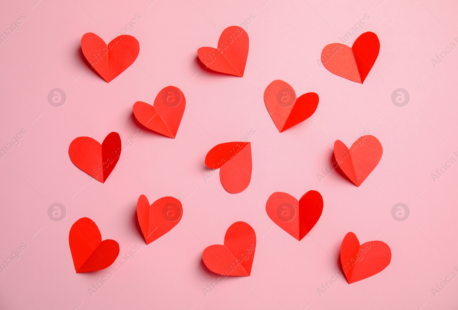 Photo of Small paper hearts on color background, top view