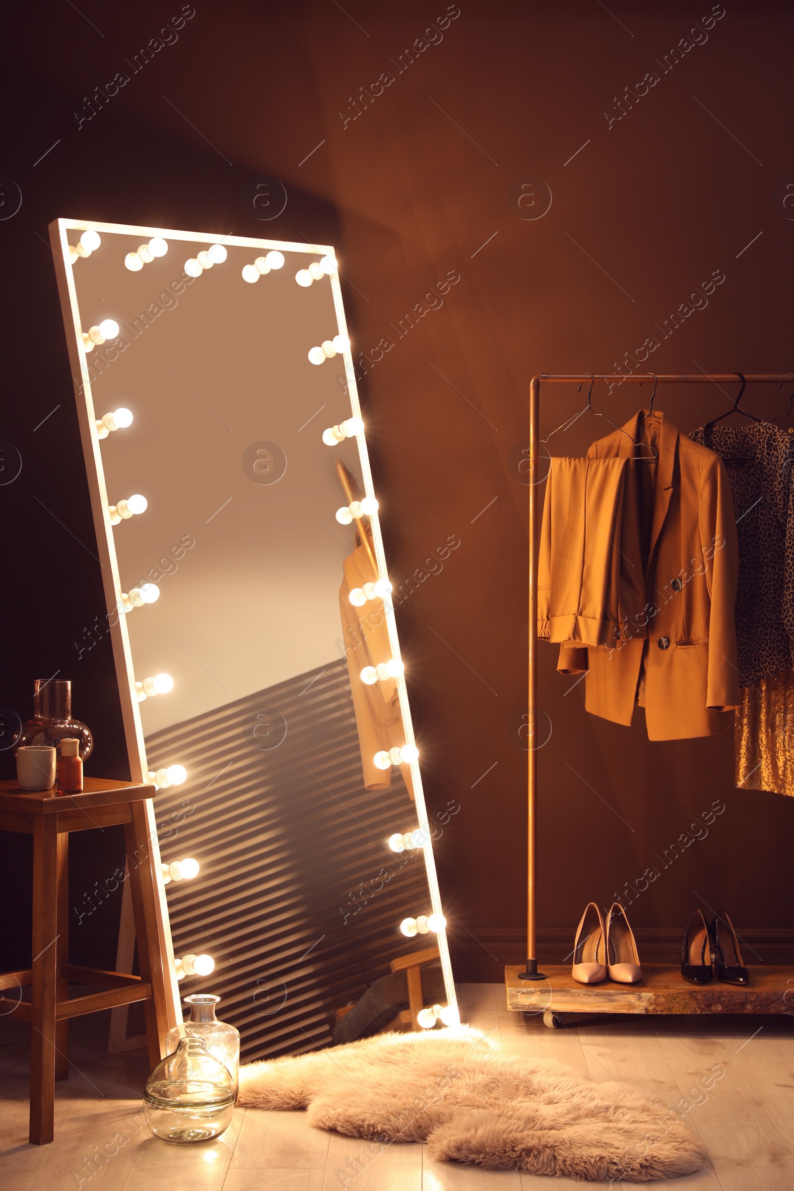 Photo of Stylish mirror with light bulbs in dressing room. Interior design