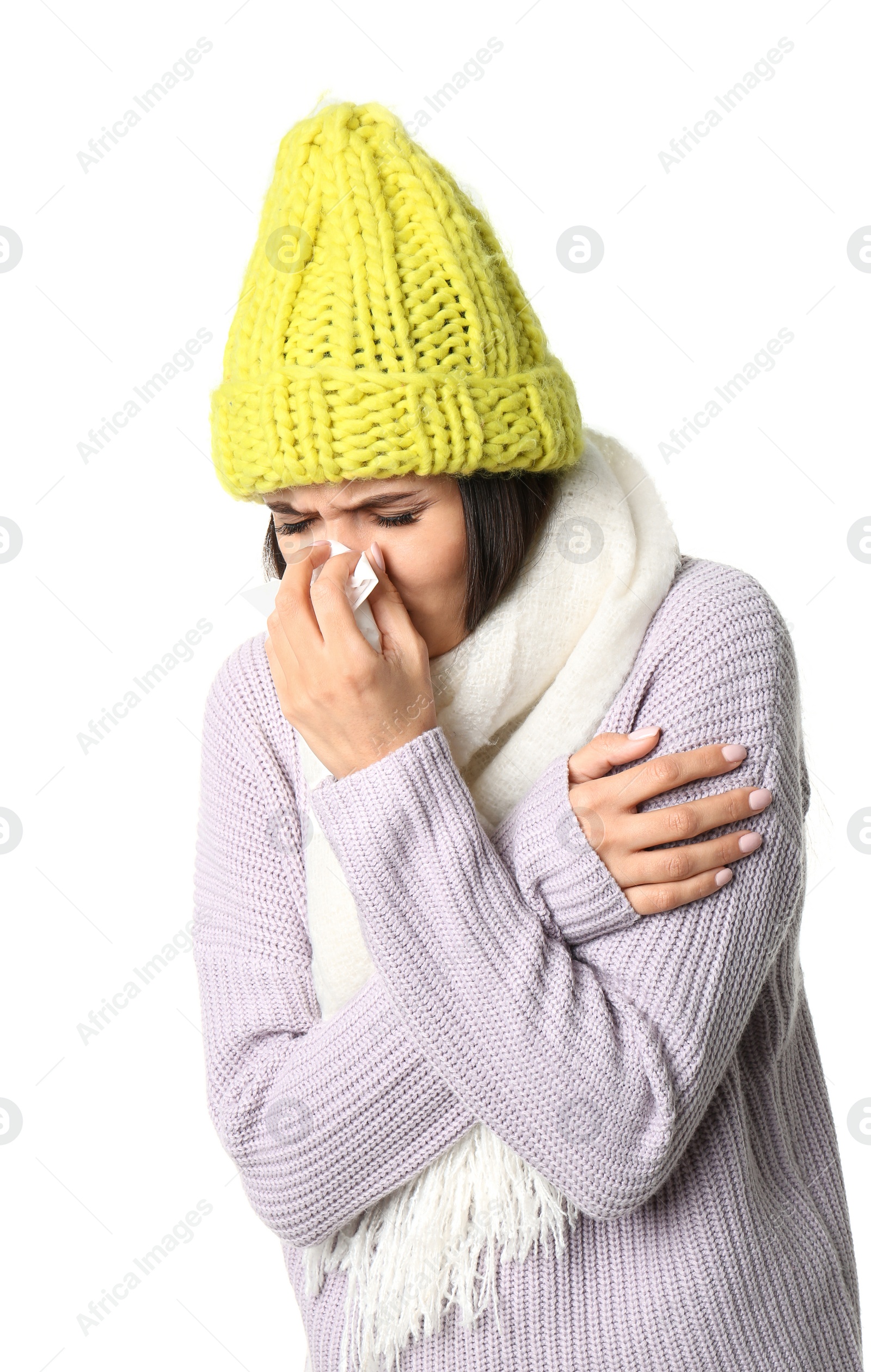 Photo of Young woman in warm clothes suffering from cold on white background