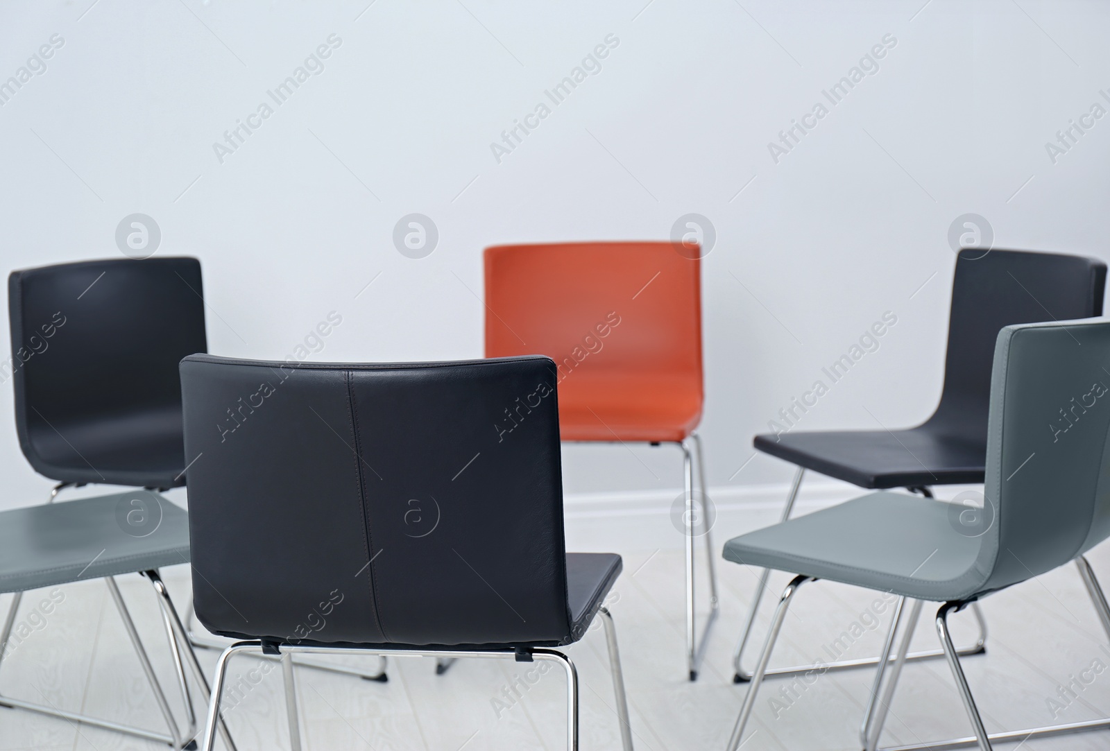 Photo of Chairs prepared for group therapy session in office. Meeting room interior