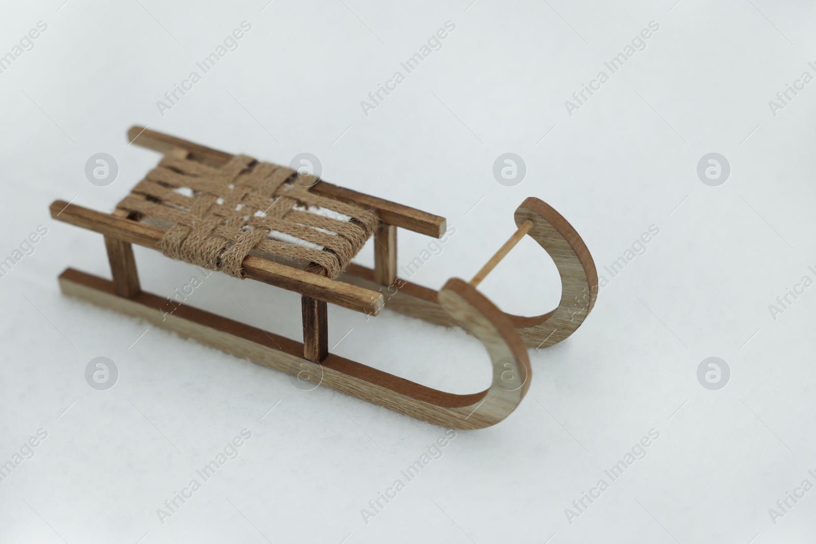 Photo of Beautiful decorative wooden sleigh on snow outdoors