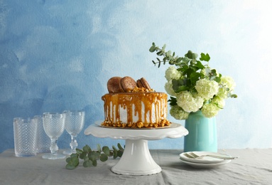 Dessert stand with delicious caramel cake on table