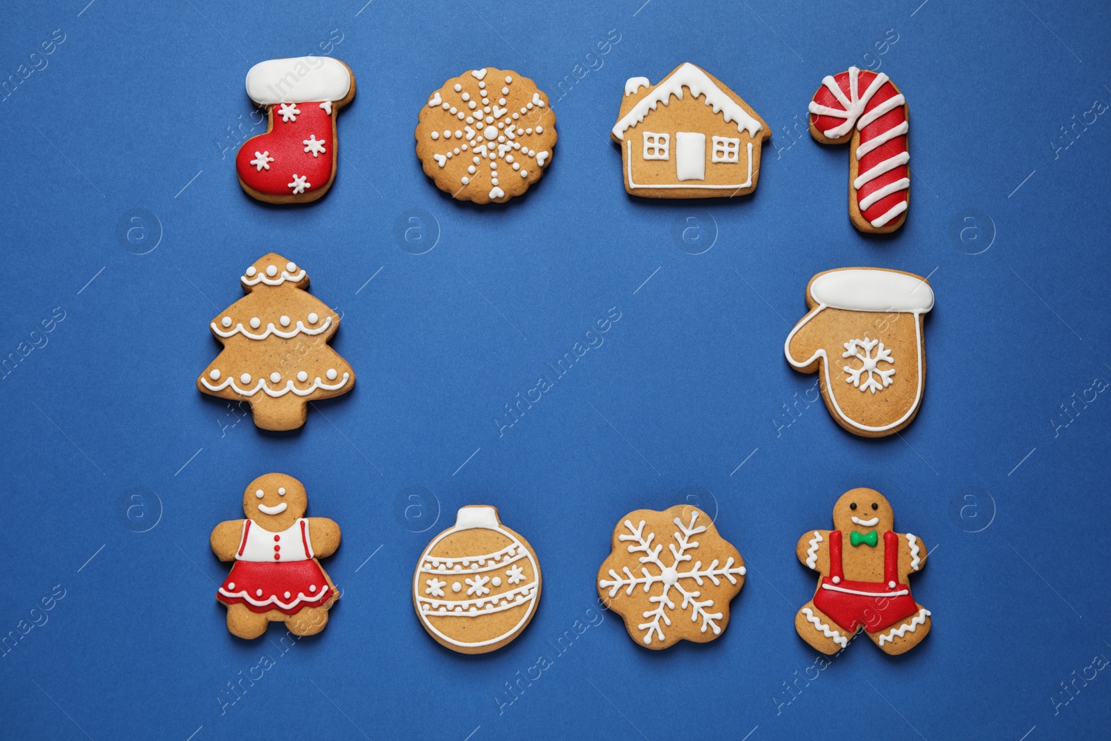 Photo of Frame made with tasty homemade Christmas cookies on blue background, flat lay. Space for text