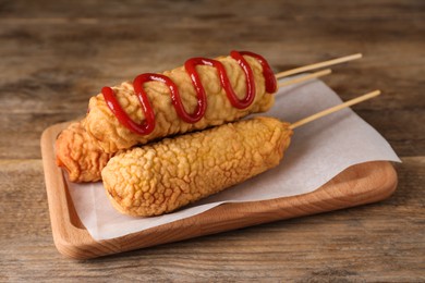 Delicious corn dogs served on wooden table