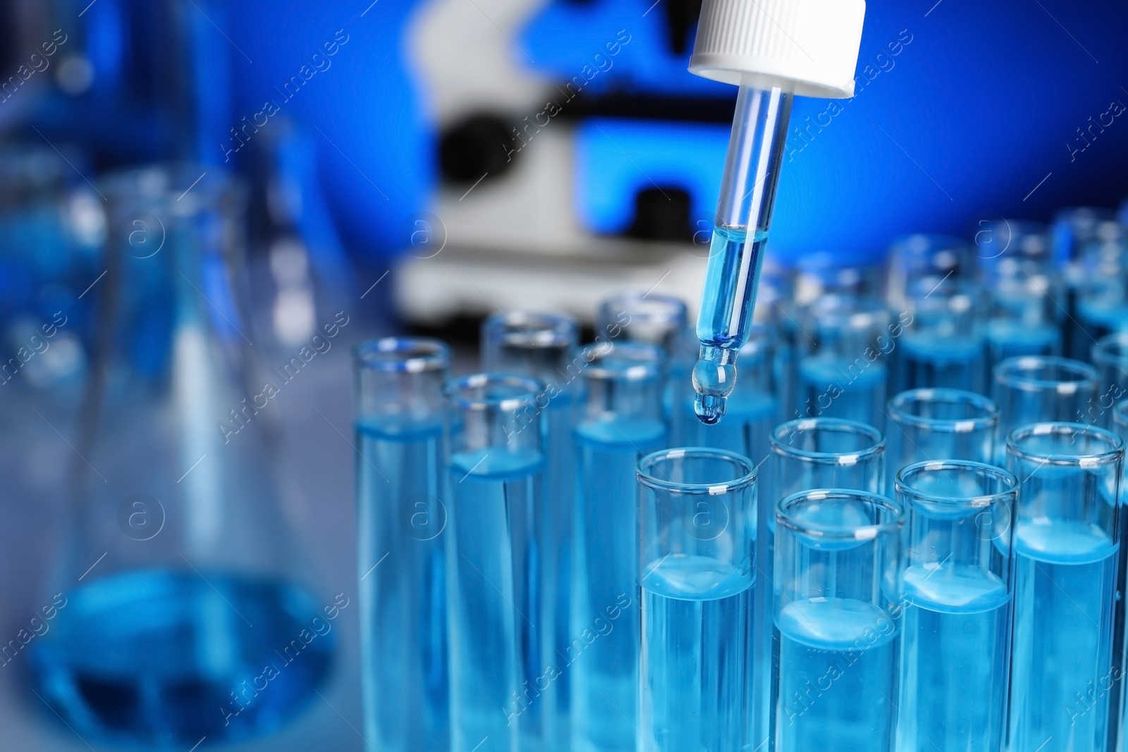 Photo of Dripping reagent into test tube with sample, closeup. Laboratory analysis