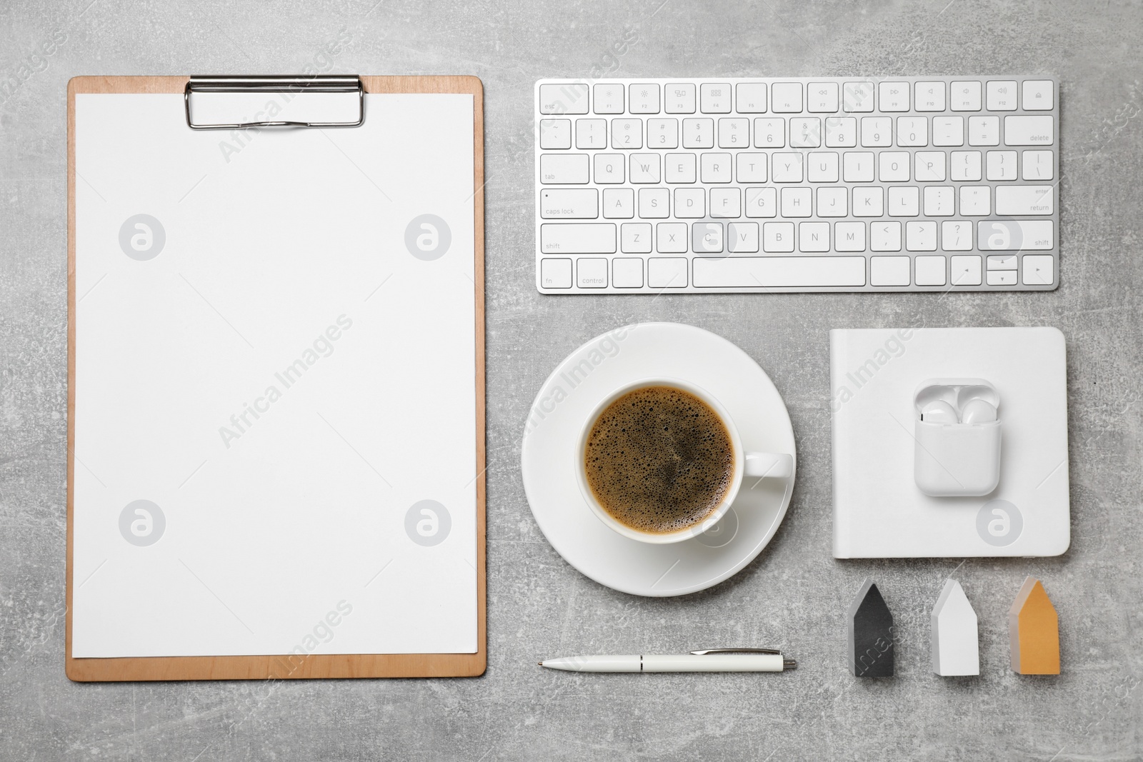 Photo of Flat lay composition with cup of coffee, computer keyboard on grey table