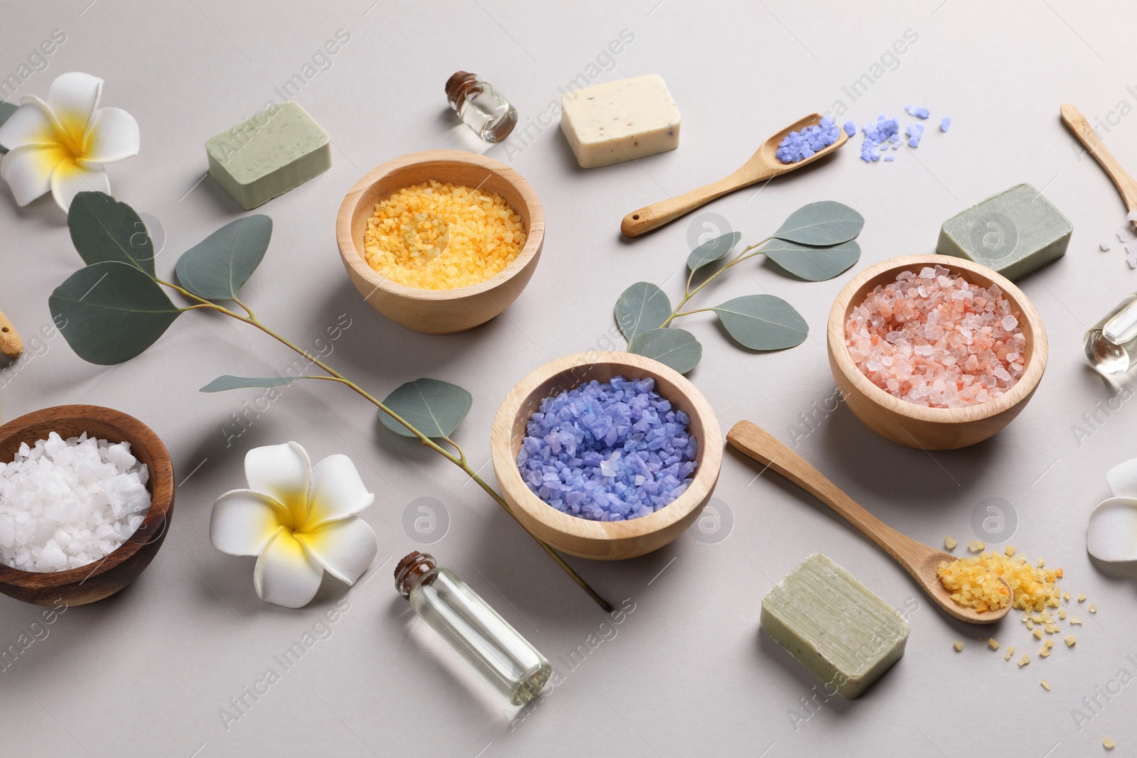 Photo of Composition with spa products and eucalyptus branches on grey background