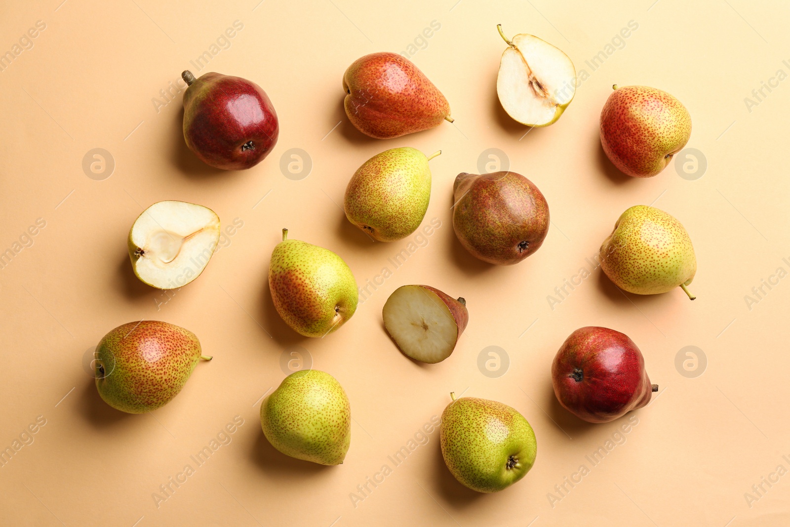 Photo of Ripe juicy pears on beige background, flat lay