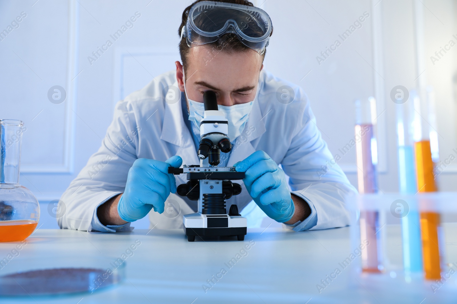 Photo of Scientist working with microscope indoors. Laboratory analysis