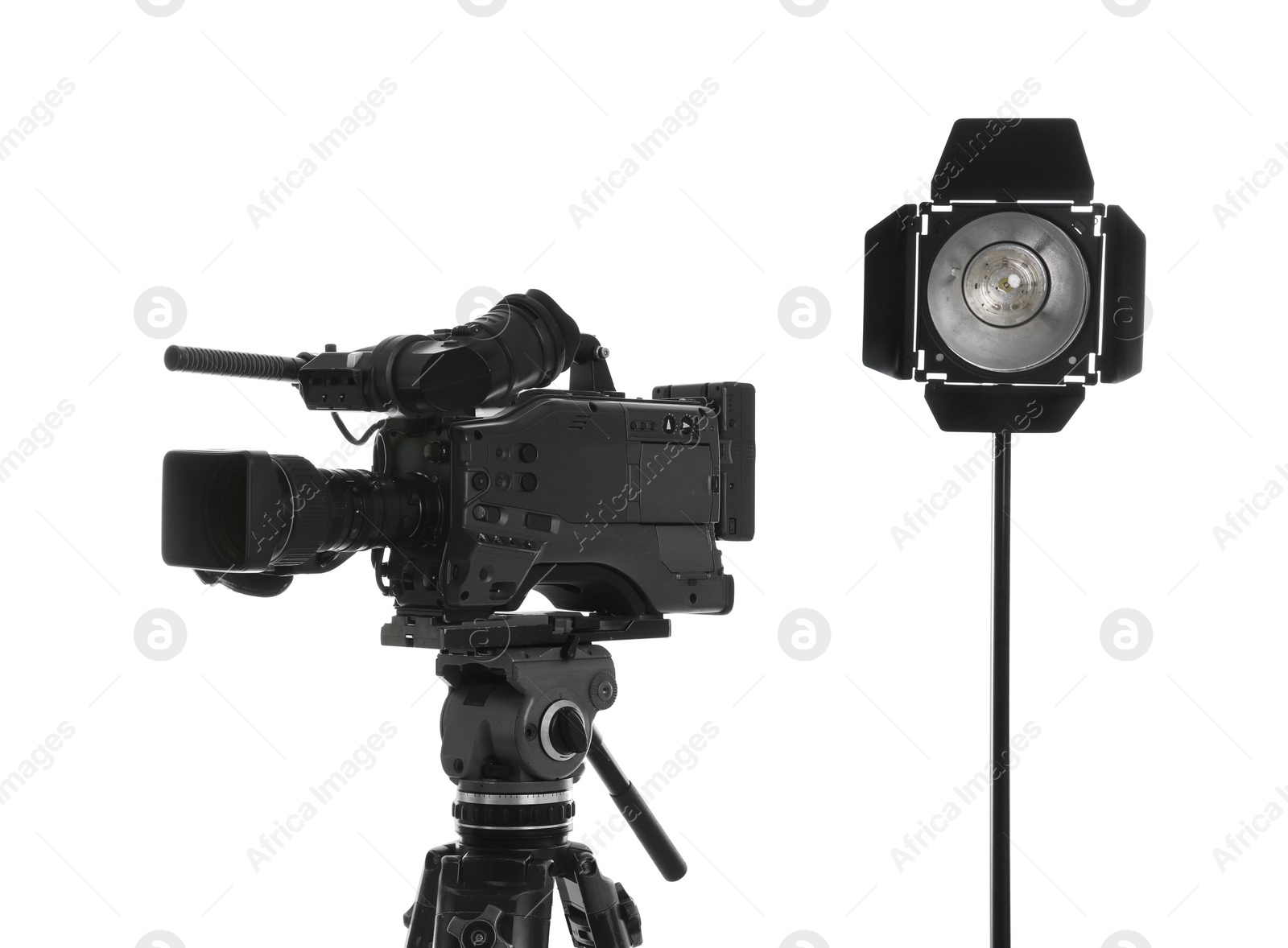 Photo of Professional video camera and lighting equipment isolated on white