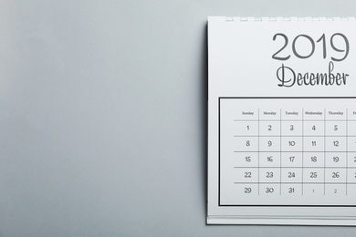 Photo of December 2019 calendar on light grey background, top view. Space for text