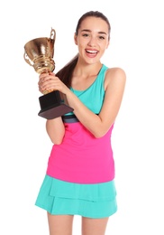 Photo of Portrait of happy young woman in tennis dress holding gold trophy cup on white background