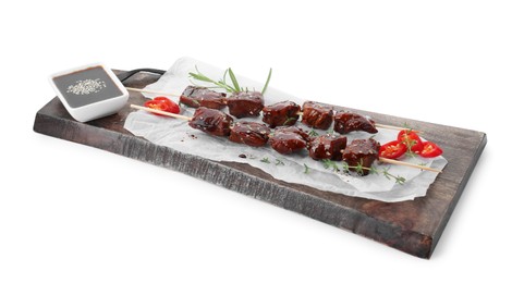 Photo of Skewers with pieces of tasty chicken meat glazed in soy sauce, herbs and cut chili pepper isolated on white