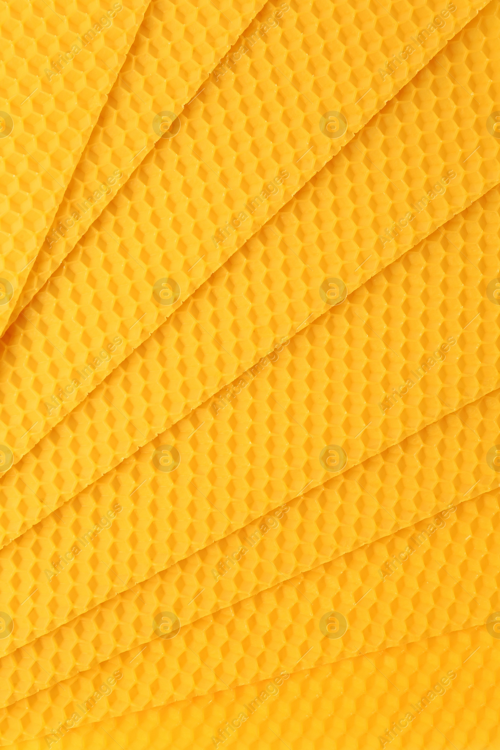 Photo of Natural beeswax sheets as background, top view