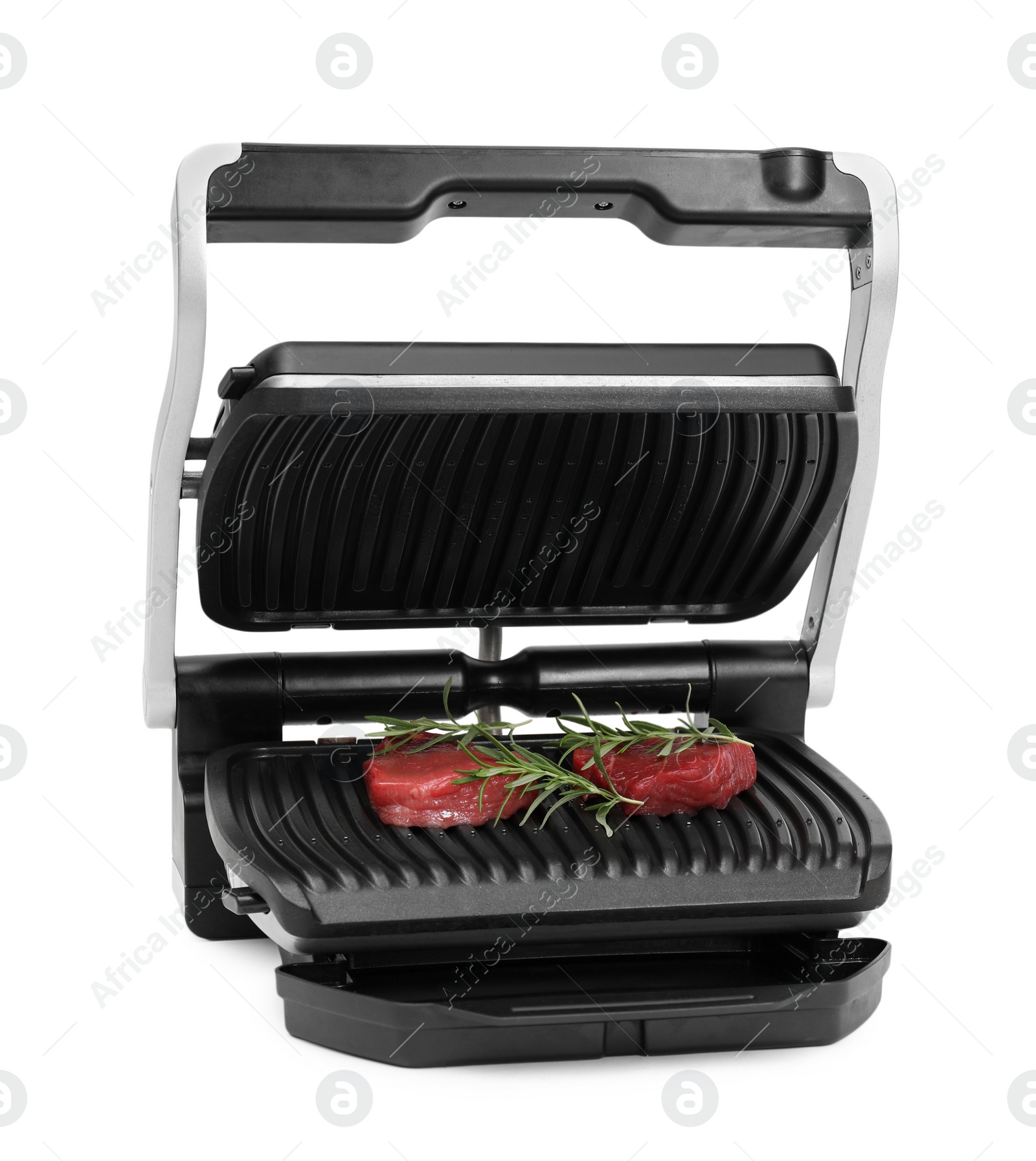 Photo of Electric grill with raw meat steaks and rosemary isolated on white