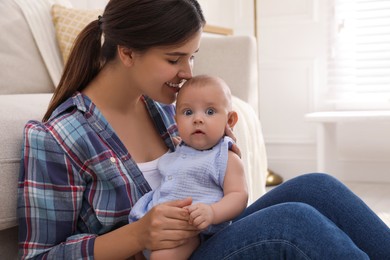 Photo of Happy young mother with her cute baby at home