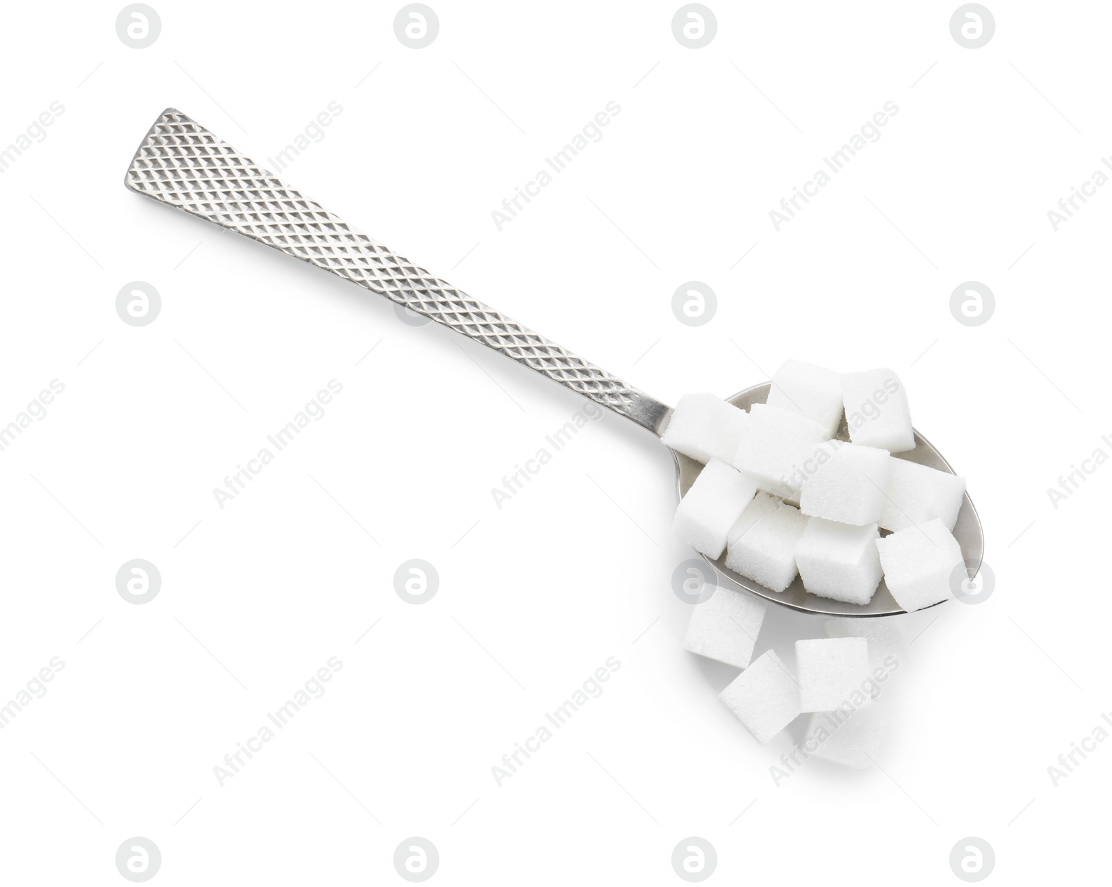 Photo of Sugar cubes and metal spoon isolated on white, top view