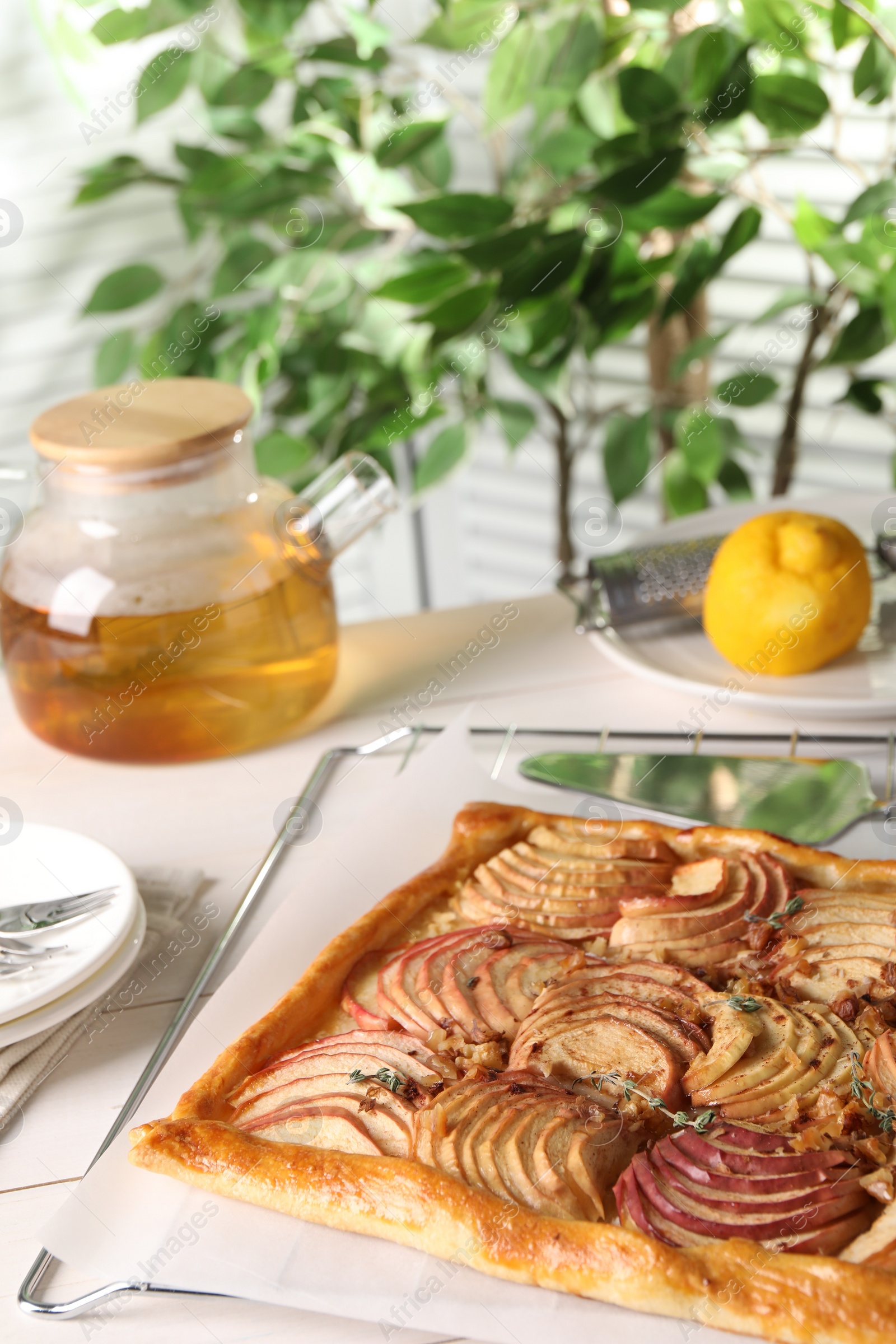 Photo of Freshly baked apple pie served on white table