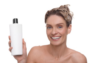 Washing hair. Portrait of beautiful happy woman with bottle on white background