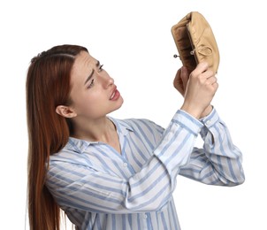 Photo of Upset woman with empty wallet on white background