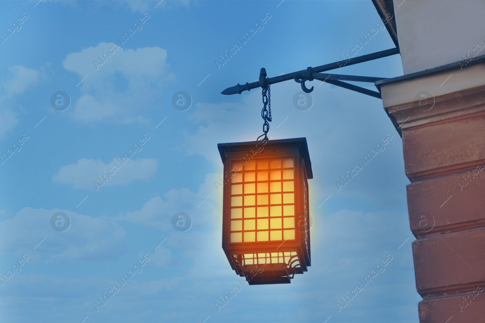 Image of Beautiful old fashioned street lamp lighting on wall of building