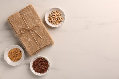 Growing microgreens. Different seeds and mats on white marble table, flat lay. Space for text