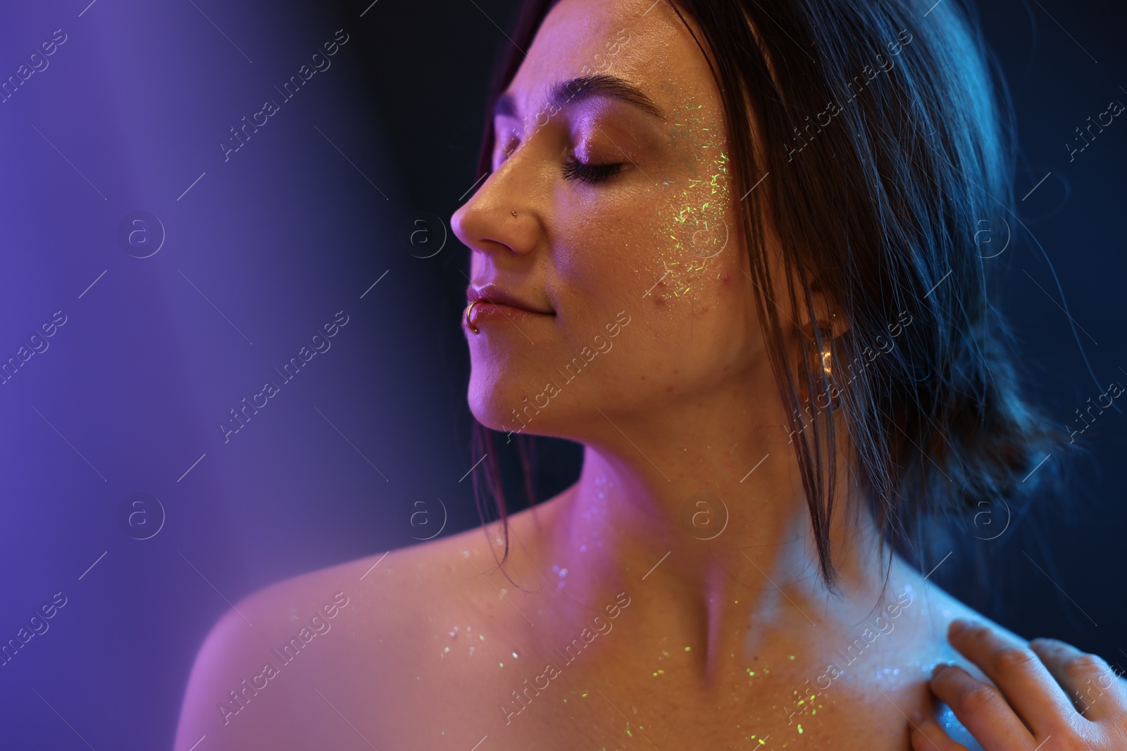 Photo of Portrait of beautiful woman on dark background in neon lights