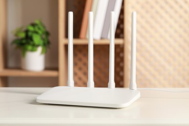 Photo of New Wi-Fi router on white table indoors